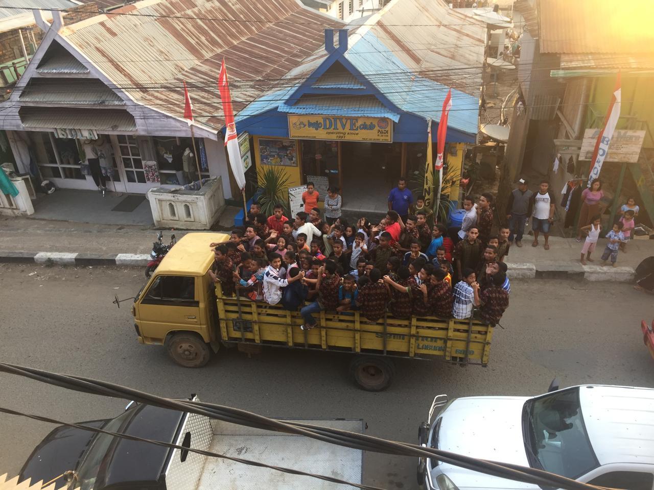 a group of people on a truck in labuan bajo