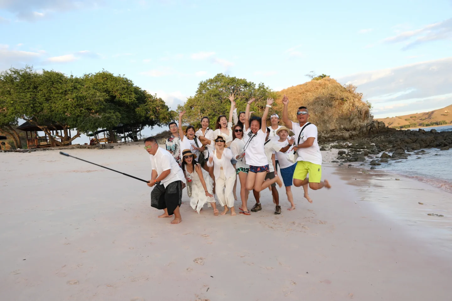 Top Activities To Do in Komodo Island: Dragons, Diving & Day Trips 4 A group of people having fun on pink beach in Komodo