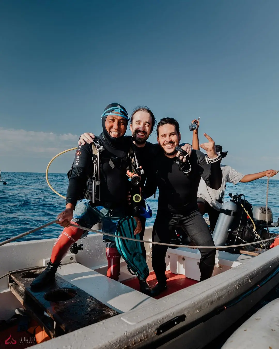 three divers on speedboat having fun