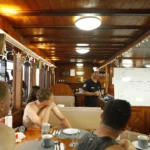Guest divers listening to La Galigo's dive guide briefing