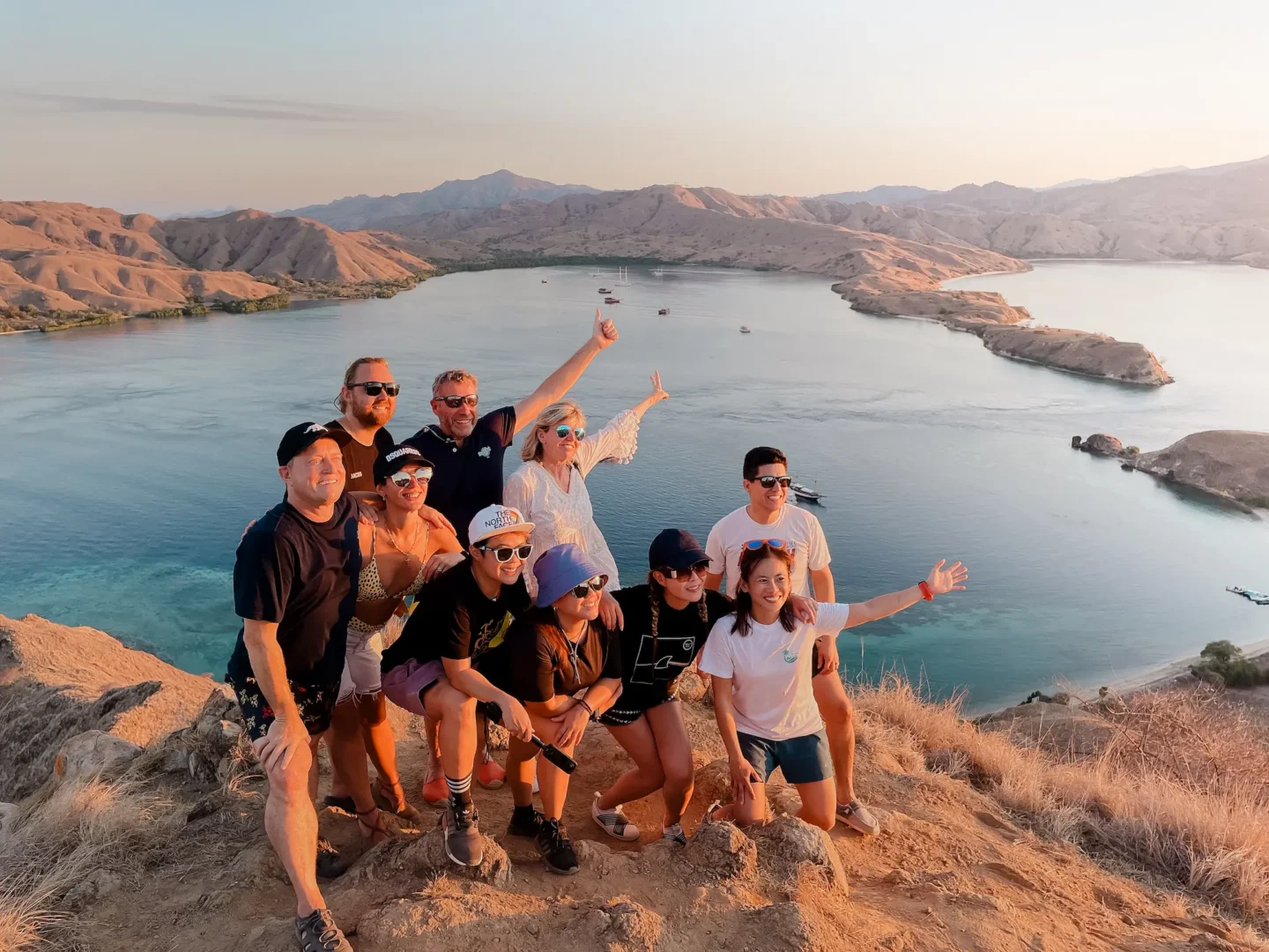 Gili Lawa: An Often Overlooked Destination in Komodo 11 a group of guests taking a picture on the summit of Gili Lawa Darat