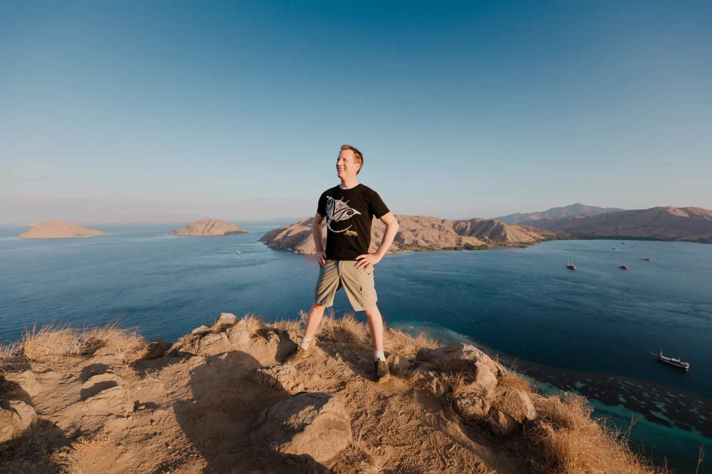 Ultimate Guide to Exploring Komodo Island 10 guest posing on top of the summit of Gili Lawa Darat