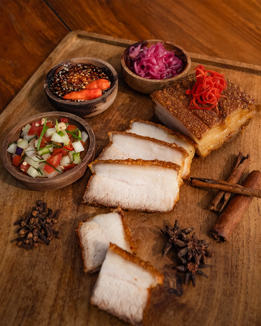 Crispy pork belly served with three different dipping sauces.