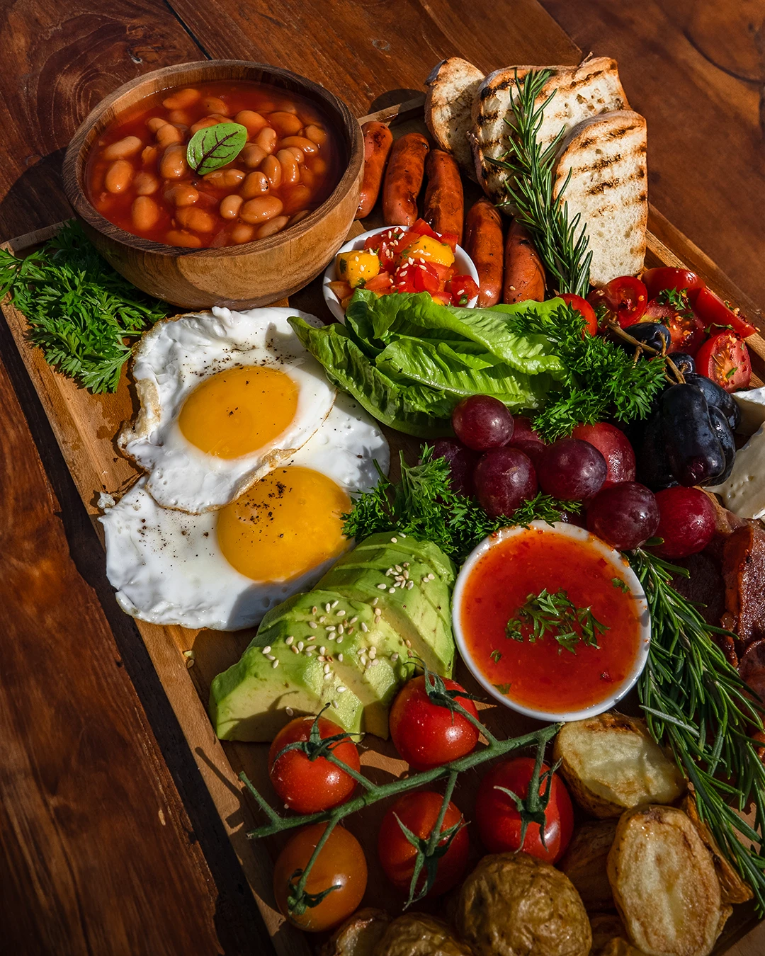 Close-up of deluxe breakfast platter with toast, eggs, and fruit.