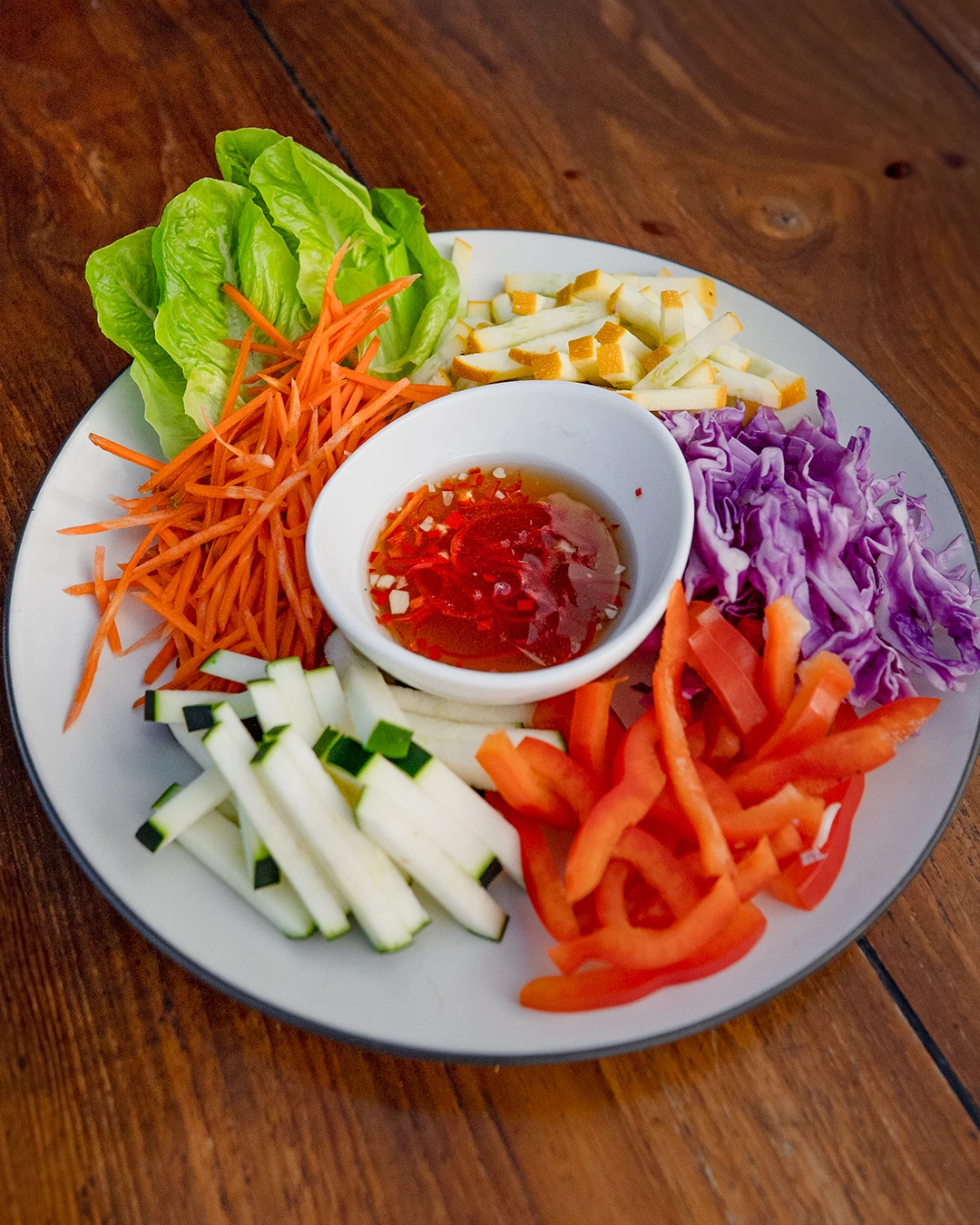 Platter of fresh-cut vegetables served with a spicy dipping sauce.