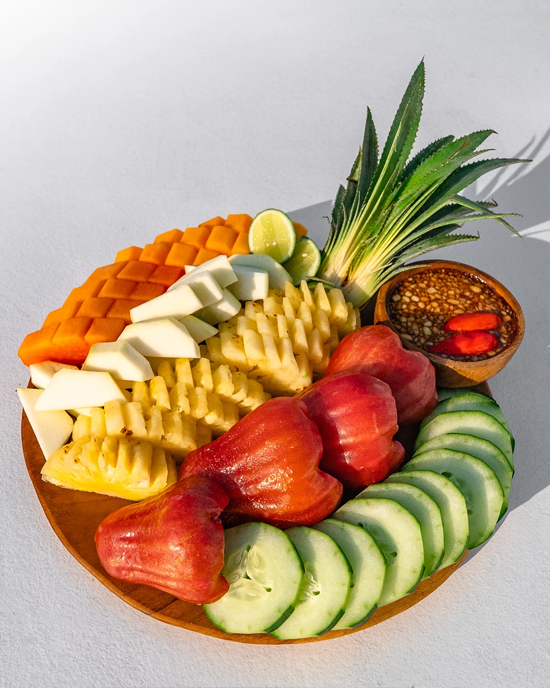 Colorful tropical fruit platter with watermelon, pineapple, and melon slices.