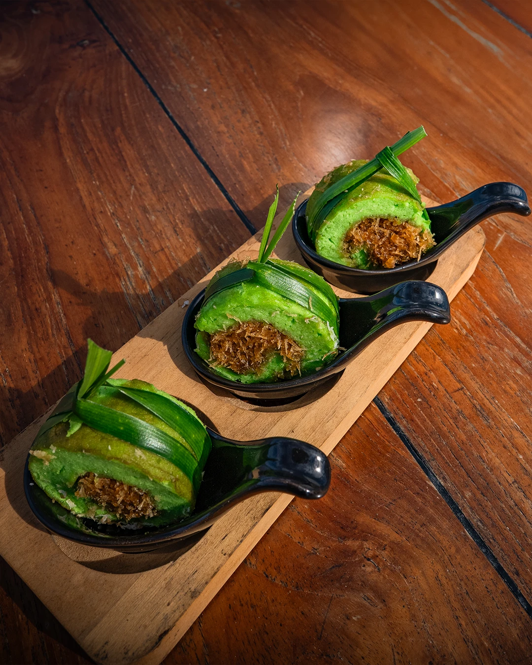 Dadar gulung, traditional Indonesian pandan crepes with sweet filling.
