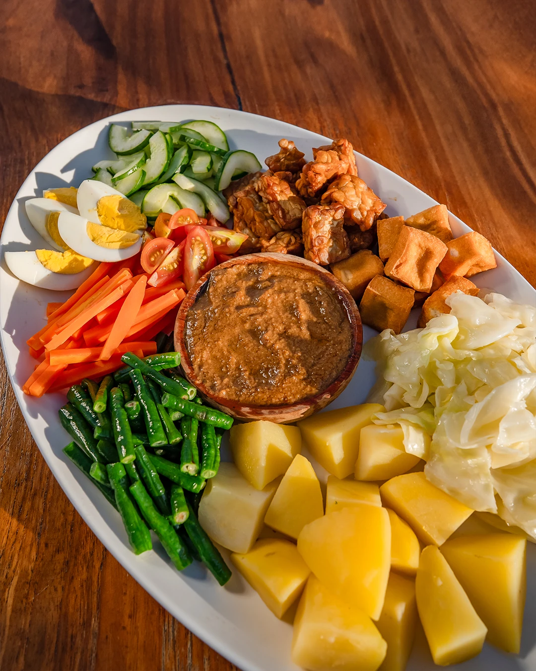 Traditional gado-gado Indonesian salad with vegetables and peanut sauce.