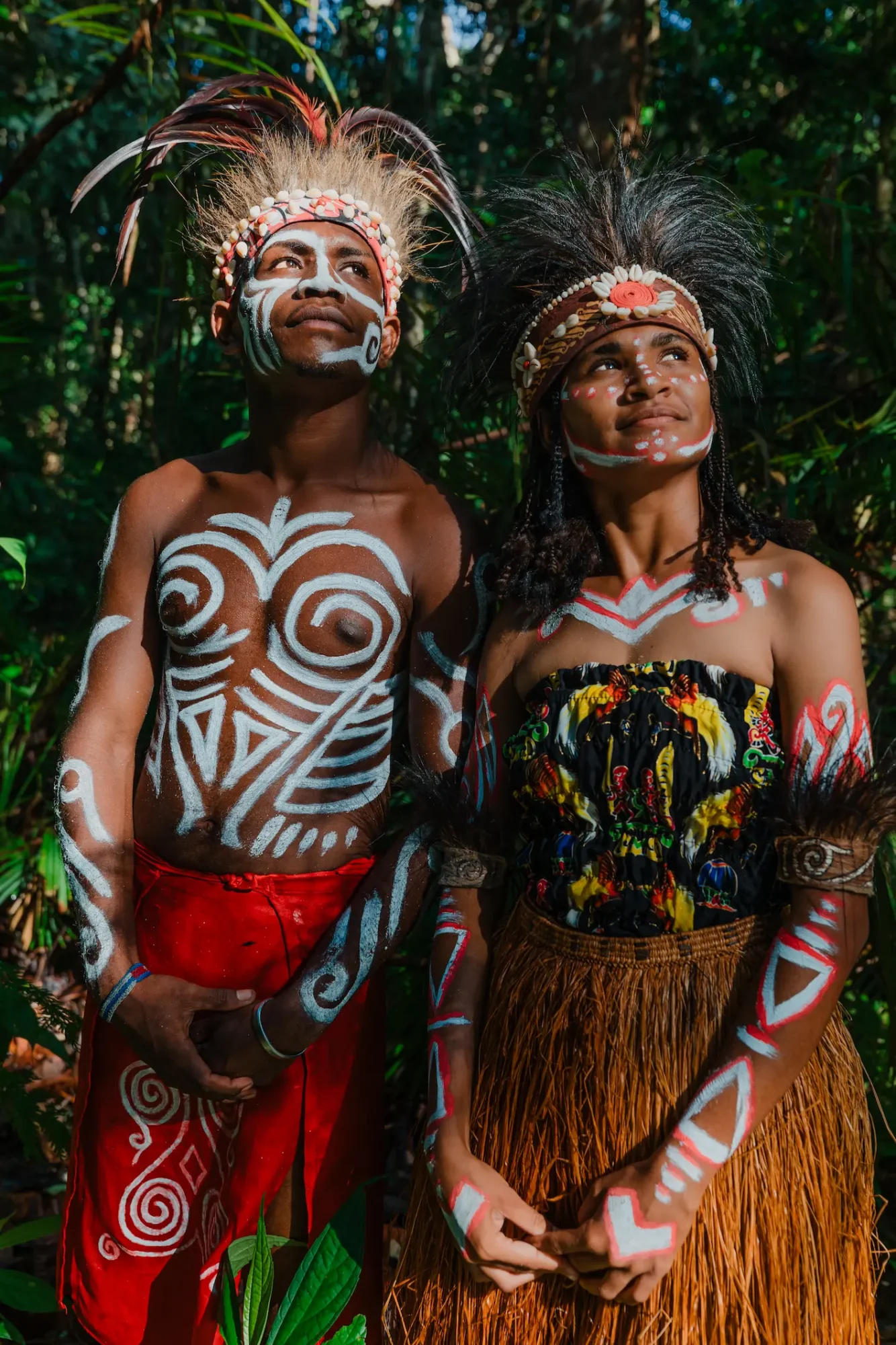 two indegenous papuan, male and female with their traditional clothing, Koteka