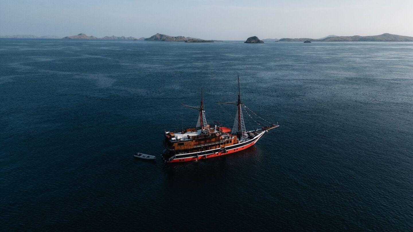La Galigo liveaboard sailing through Sumbawa waters during a multi-day diving expedition, highlighting remote island scenery and access to lesser-visited dive sites